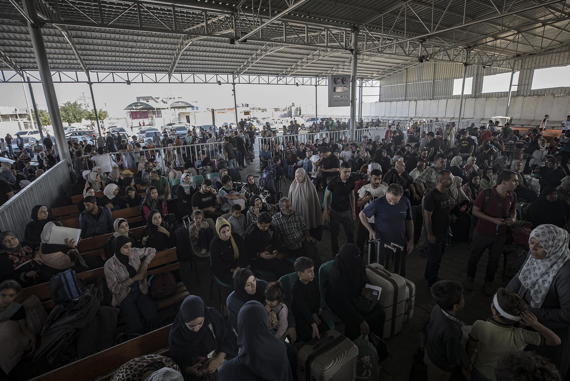 Cientos de ciudadanos palestinos esperan para cruzar a Egipto este miércoles, en el cruce fronterizo de Rafah entre la Franja de Gaza y Egipto. Foto: EFE.